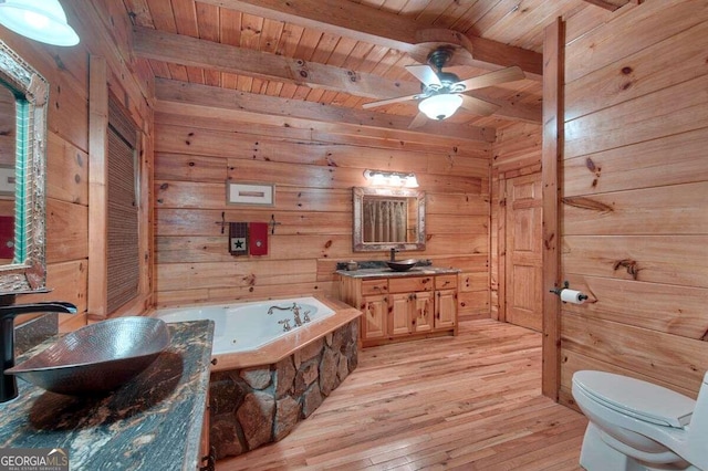 bathroom featuring hardwood / wood-style flooring, beam ceiling, wooden ceiling, and wooden walls