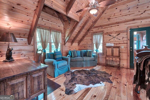 living room featuring beam ceiling, a healthy amount of sunlight, wooden ceiling, wood walls, and light hardwood / wood-style floors