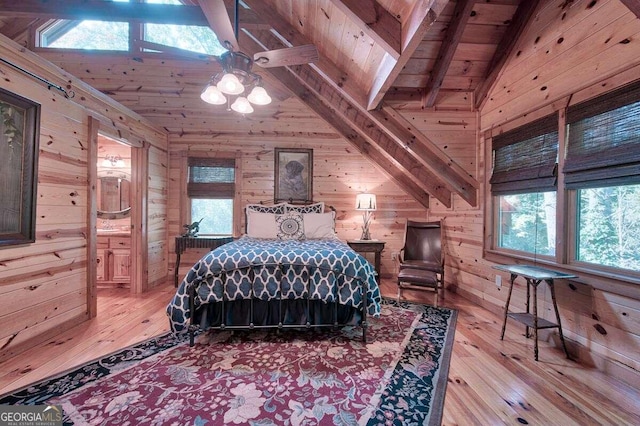 bedroom with vaulted ceiling with beams, wooden walls, ensuite bath, and wooden ceiling