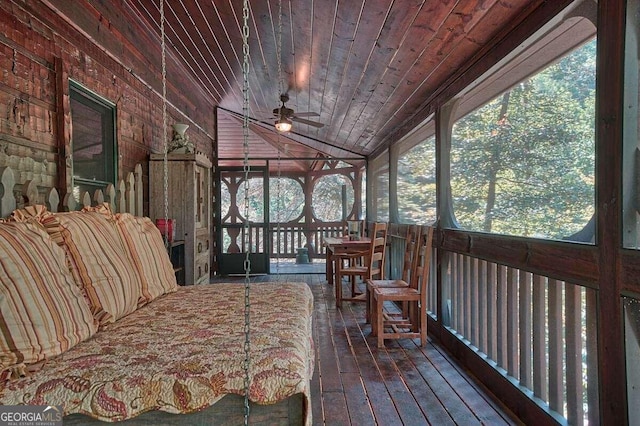 sunroom / solarium featuring ceiling fan, wooden ceiling, and vaulted ceiling