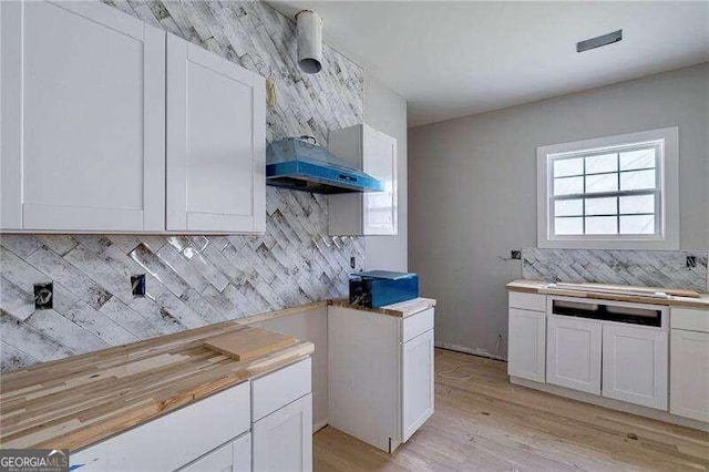 kitchen featuring white cabinetry and decorative backsplash