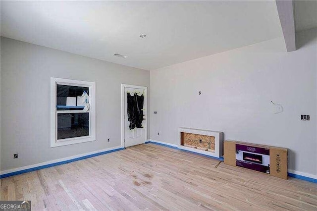 unfurnished living room featuring light wood-type flooring