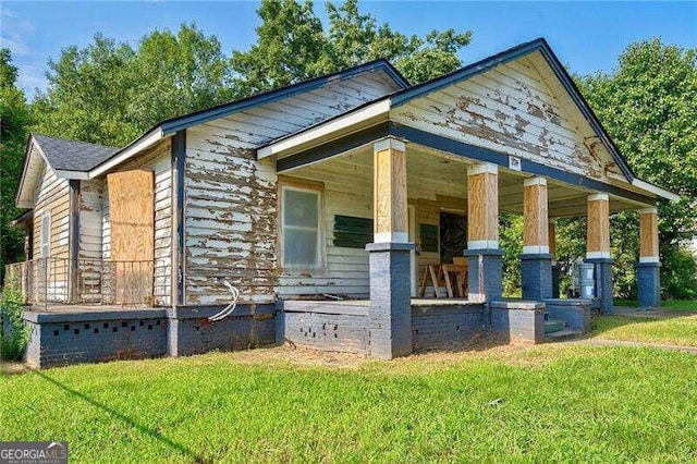 view of side of property with a yard