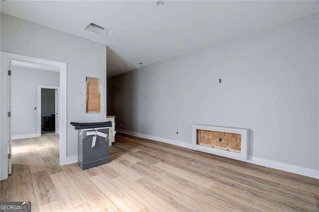 unfurnished living room featuring light wood-type flooring