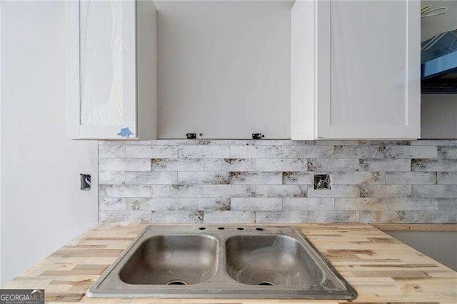 room details featuring white cabinetry and butcher block countertops