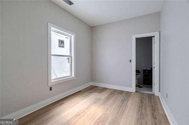 unfurnished room with hardwood / wood-style floors