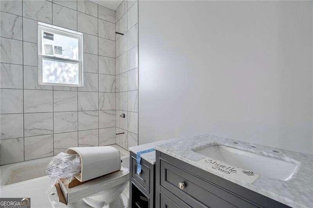 full bathroom with tiled shower / bath combo, vanity, and toilet