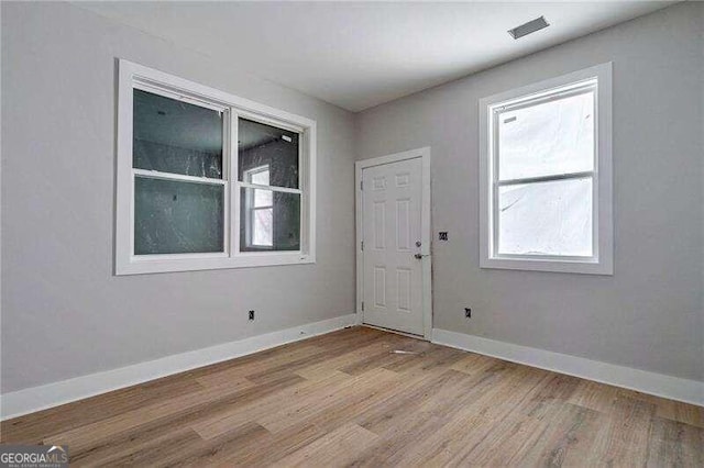 spare room with light hardwood / wood-style flooring