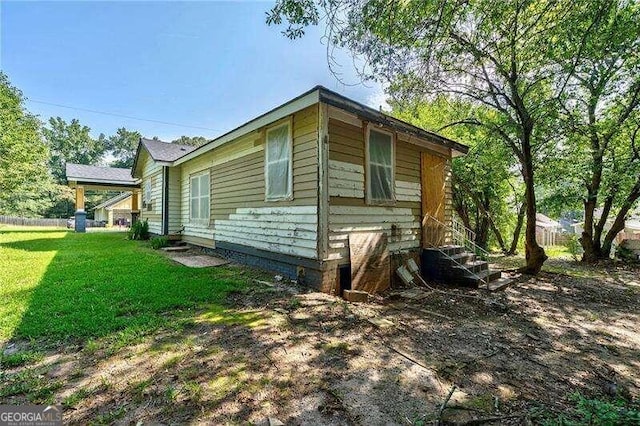 view of property exterior with a lawn