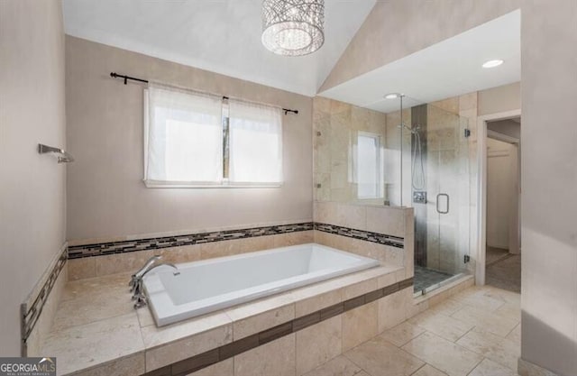 full bath featuring a garden tub, vaulted ceiling, a shower stall, and a notable chandelier