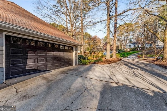 exterior space featuring roof with shingles