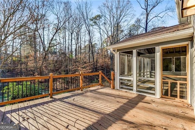 wooden terrace featuring a sunroom