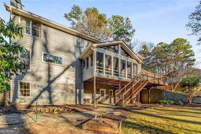 rear view of property featuring a sunroom and stairway