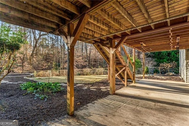 view of patio with stairs and fence