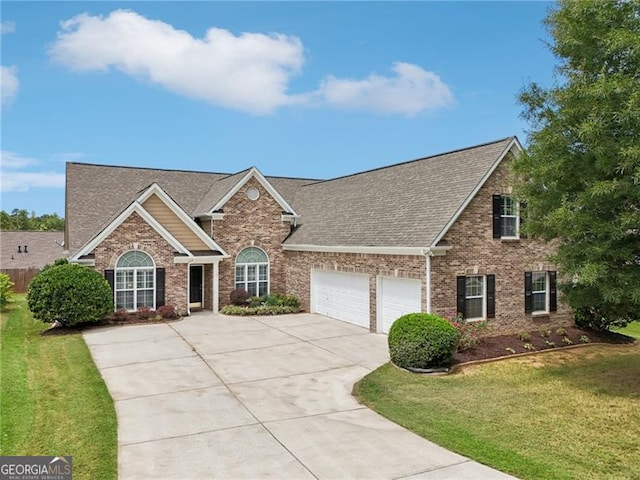 view of front of property with a front lawn and a garage