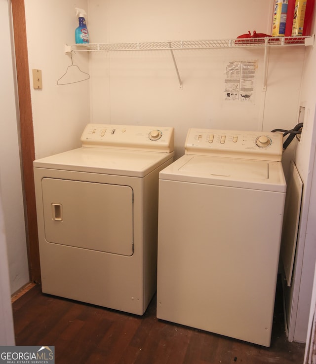 clothes washing area featuring dark hardwood / wood-style floors and washing machine and clothes dryer