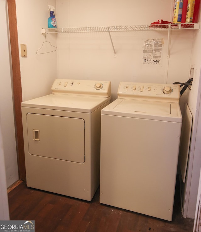 clothes washing area featuring independent washer and dryer, laundry area, and dark wood-style flooring