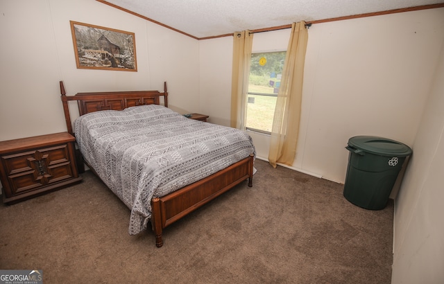 bedroom featuring dark carpet, a textured ceiling, lofted ceiling, and ornamental molding