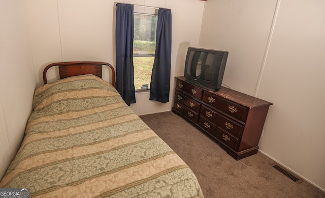 bedroom featuring dark carpet