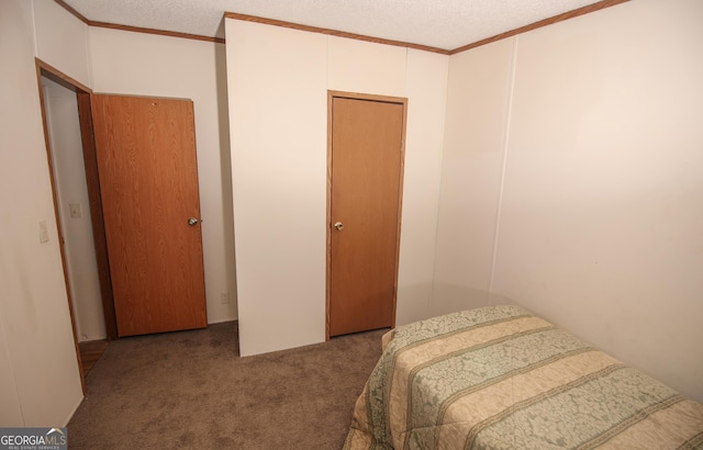 carpeted bedroom featuring crown molding and a textured ceiling