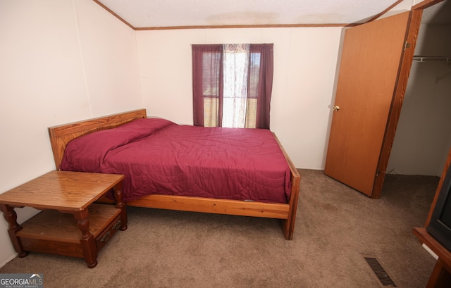 carpeted bedroom with ornamental molding and visible vents