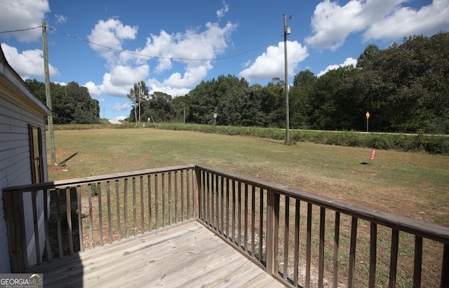 wooden deck featuring a yard