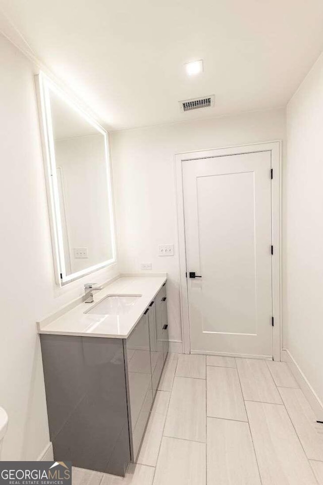 bathroom featuring vanity, toilet, and tile patterned flooring