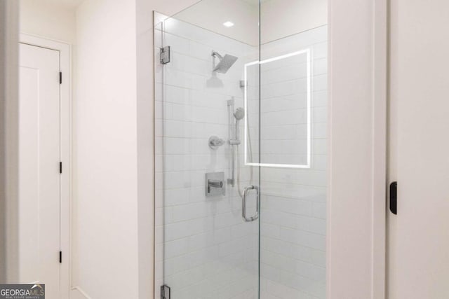 bathroom with a shower with shower door