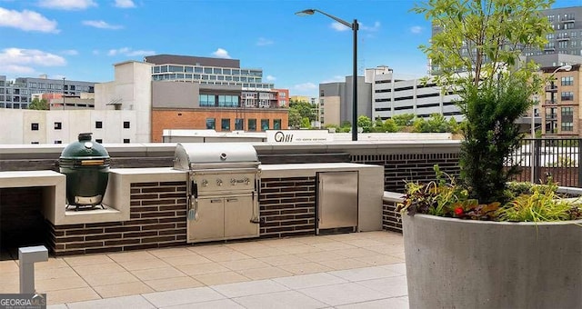 view of patio / terrace with exterior kitchen and a grill