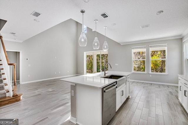 kitchen featuring a center island with sink, white cabinetry, dishwasher, and pendant lighting