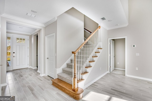 entryway featuring ornamental molding