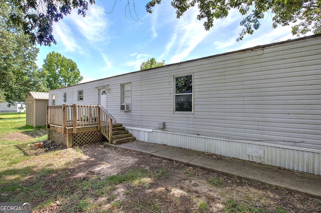 rear view of house featuring a wooden deck