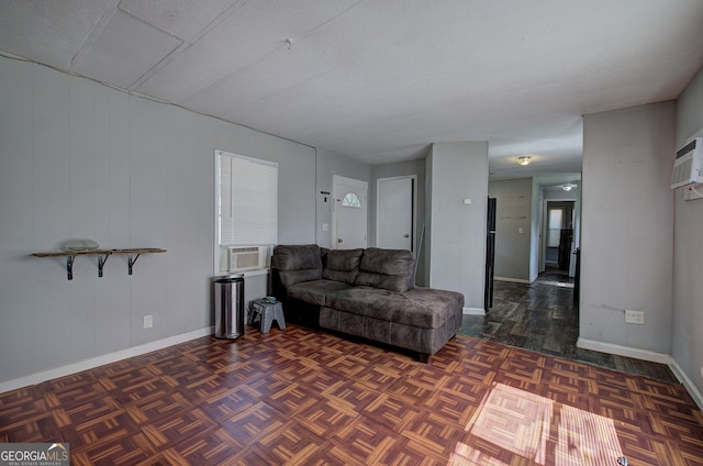 living room featuring dark parquet flooring, a textured ceiling, and cooling unit