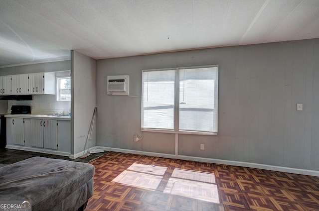 interior space featuring dark parquet floors, tasteful backsplash, sink, and a wall mounted air conditioner