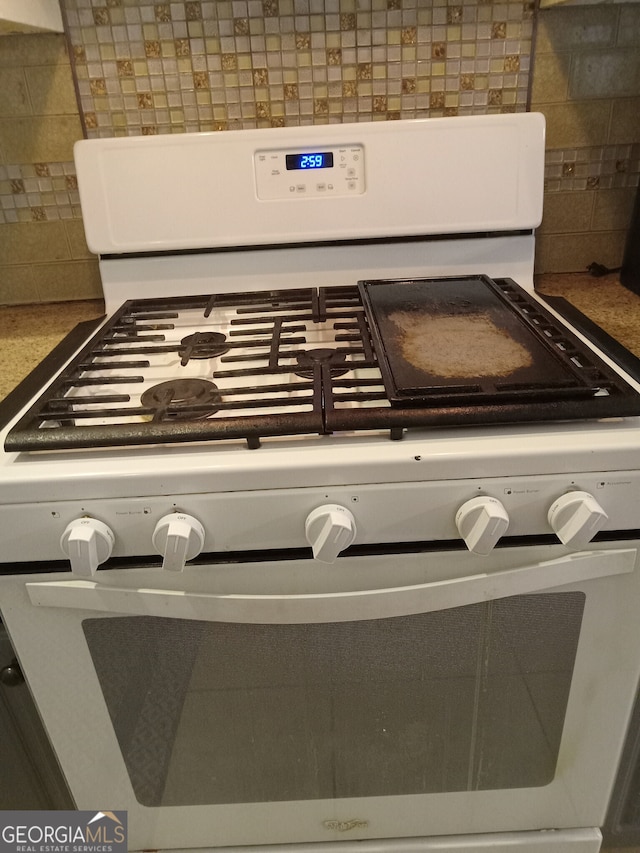 interior details featuring tasteful backsplash and gas range gas stove