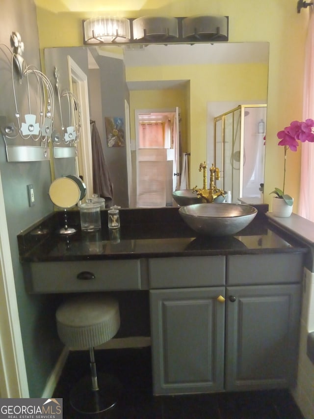 bathroom featuring a stall shower and vanity