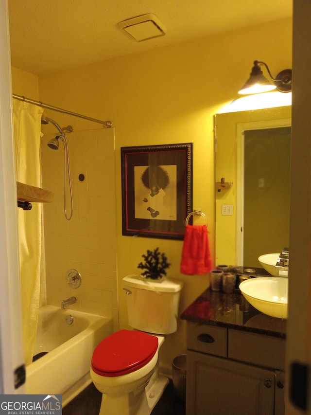 bathroom with toilet, shower / bath combination with curtain, and vanity