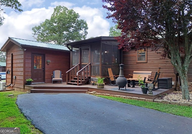 exterior space with a patio area and a sunroom