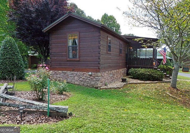 view of side of property with a lawn