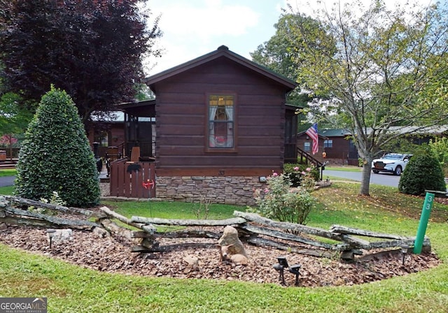 view of side of property with a yard