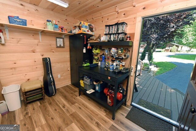 interior space with wood-type flooring, wood walls, and wood ceiling