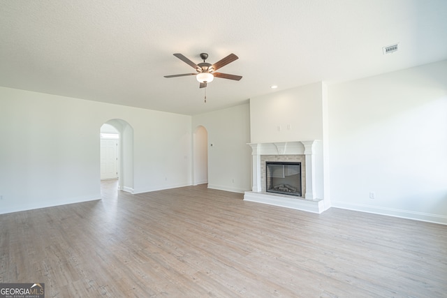 unfurnished living room with ceiling fan and light wood-type flooring