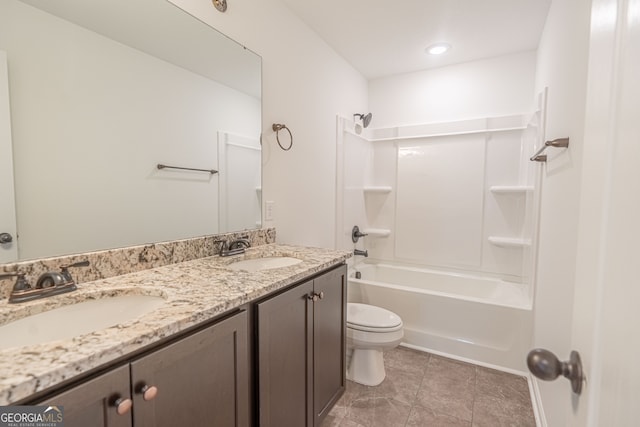 full bathroom featuring double sink vanity,  shower combination, toilet, and tile patterned flooring