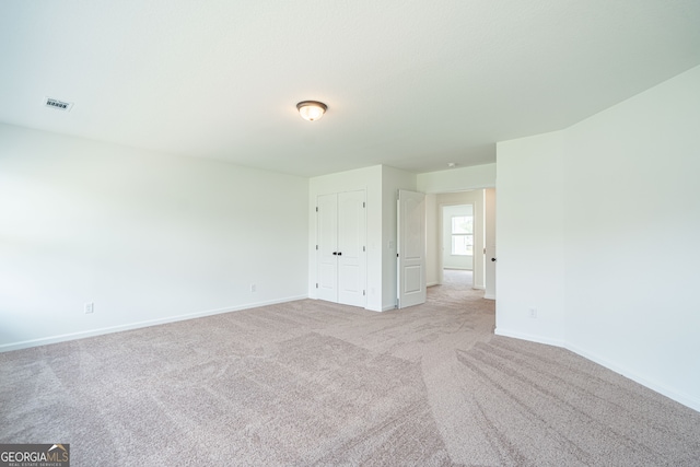 unfurnished bedroom with light carpet