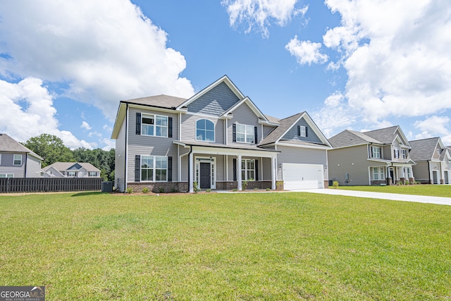 view of front of property featuring a front yard and a garage