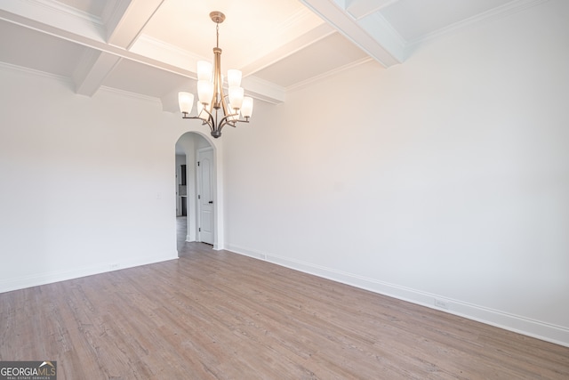 unfurnished room with coffered ceiling, hardwood / wood-style flooring, beamed ceiling, and an inviting chandelier