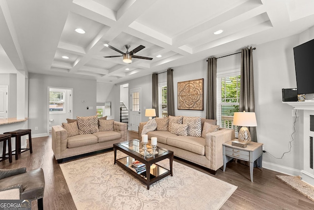 living room with ceiling fan, coffered ceiling, beam ceiling, and hardwood / wood-style flooring