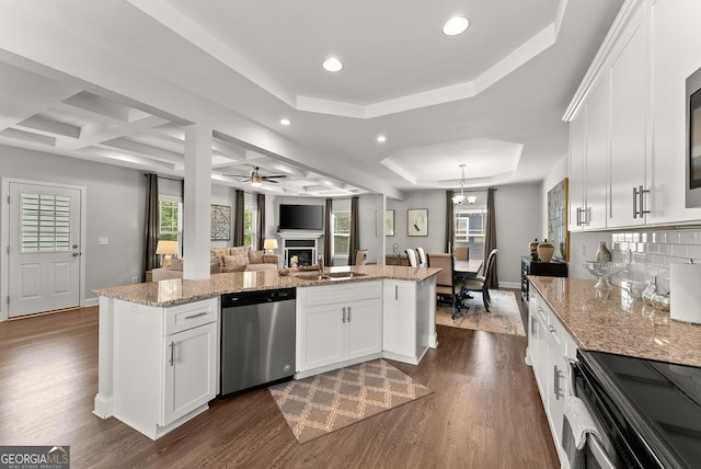 kitchen featuring coffered ceiling, dark wood-type flooring, dishwasher, and a tray ceiling