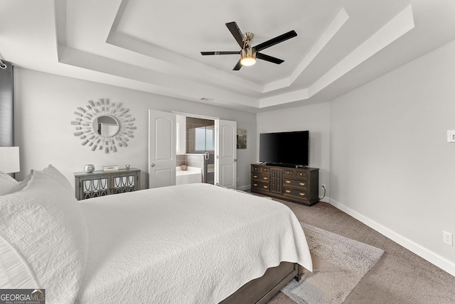 carpeted bedroom featuring ceiling fan and a raised ceiling