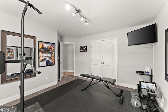 exercise area featuring carpet flooring and rail lighting